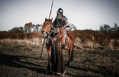 Person riding horse on field