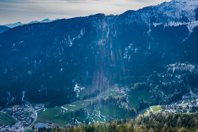 Aerial view of snowcapped mountains by sea