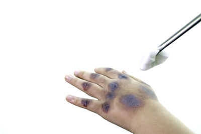 Close-up of woman hand over white background