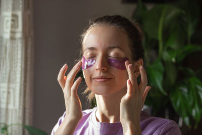 Young woman with purple patches under eyes. skin care and daily morning routine concept.