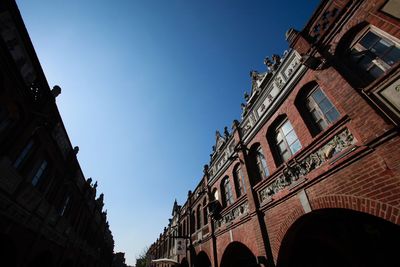 Low angle view of buildings against clear blue sky