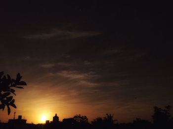 Low angle view of silhouette trees against sky at sunset