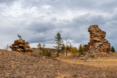 Rock formations on landscape against sky