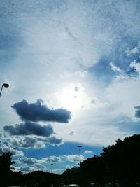 Low angle view of silhouette trees against sky