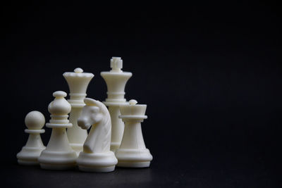 Close-up of chess pieces against black background