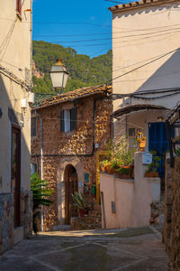 Street amidst buildings in town against sky