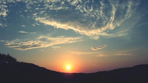 Scenic view of silhouette mountains against sky during sunset