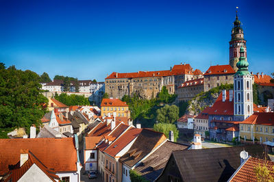 View of buildings in city against clear blue sky