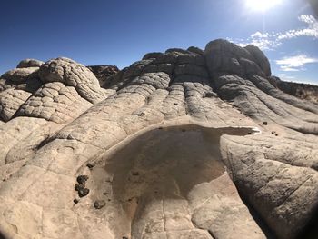 Low angle view of rock formation against sky