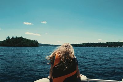 Rear view of woman sitting in boat