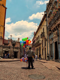 Colonial street with ballons seller in guanajuato, mexico