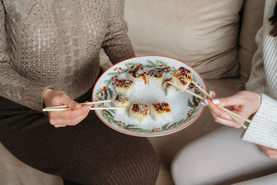 Midsection of woman holding cake