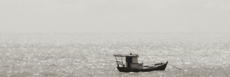 Lifeguard hut in sea against sky