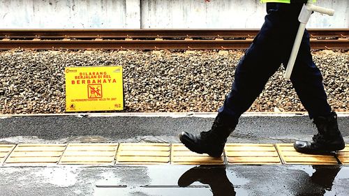 Low section of woman on railroad tracks