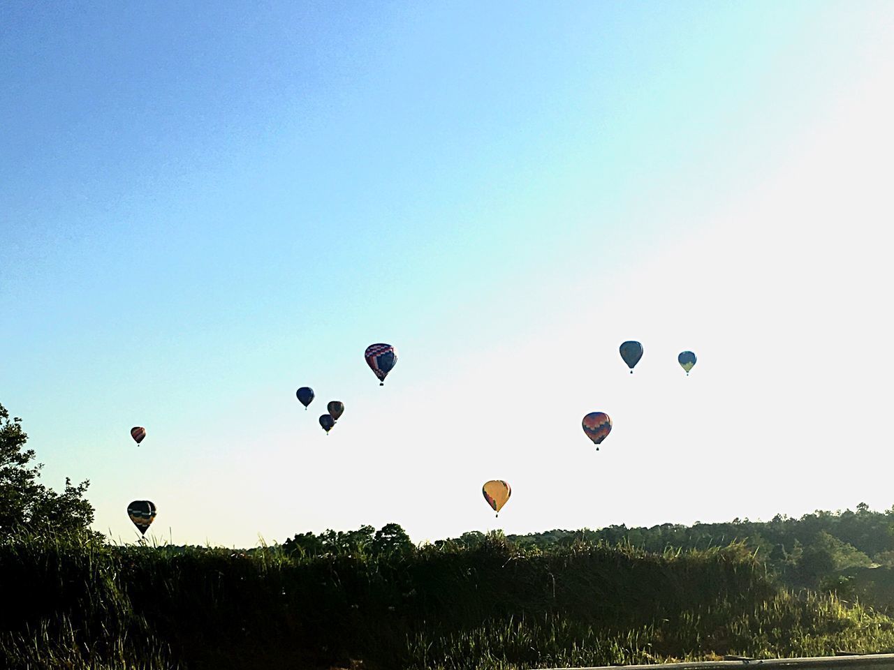 VIEW OF HOT AIR BALLOONS AGAINST BLUE SKY