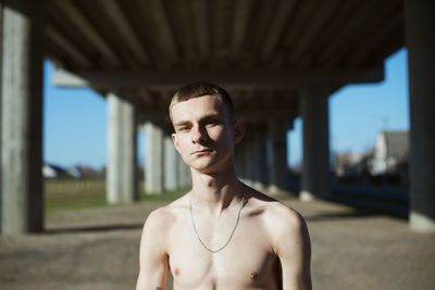 Portrait of shirtless young man outdoors