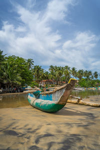 Colorful traditional fishing boat on the beach, arugam bay, sri lanka