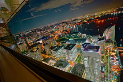 High angle view of illuminated city buildings at night