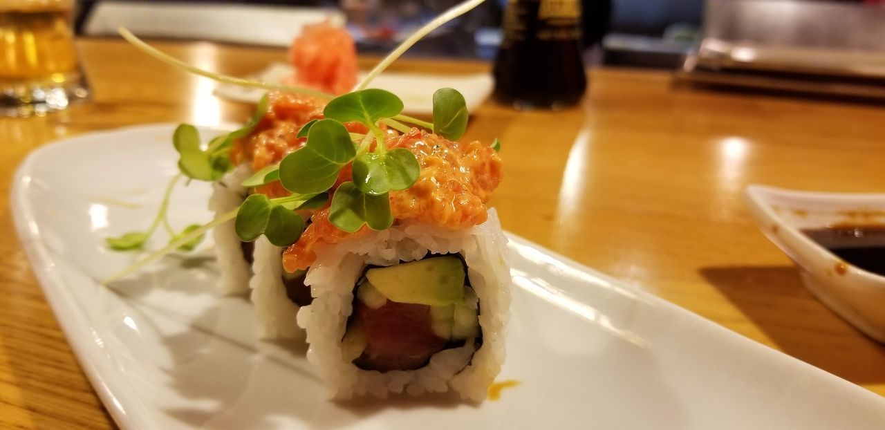 CLOSE-UP OF SUSHI SERVED ON TABLE IN RESTAURANT