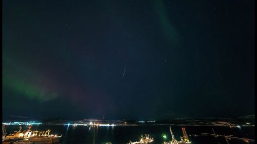 Scenic view of lake against sky at night