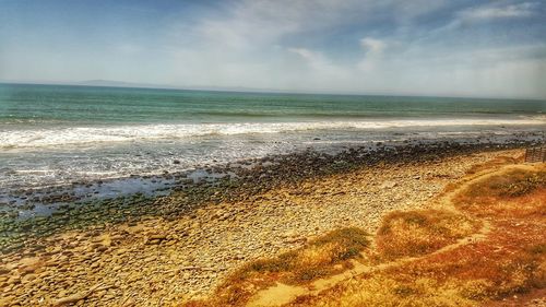 Scenic view of beach against sky