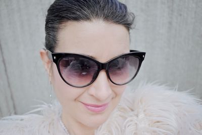 Close-up portrait of smiling woman wearing sunglasses