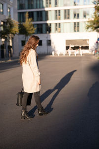 Young woman walking on city street