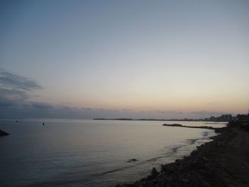 Scenic view of sea against clear sky during sunset