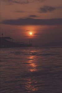 Scenic view of sea against orange sky