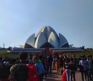 Rear view of people at music concert against sky