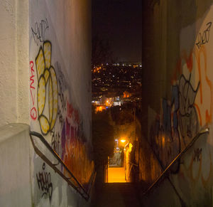 Close-up of graffiti on wall in city at night