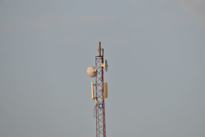 Low angle view of communications tower against sky