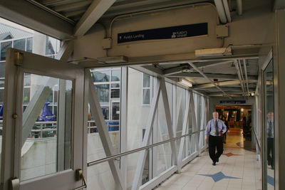 Rear view of woman walking in corridor of building