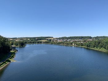 Scenic view of river against clear blue sky