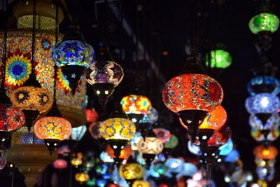 Illuminated lanterns hanging in market for sale