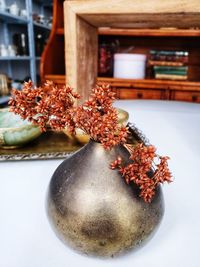 Small vintage bronze vase with dry flowers.