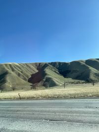 Scenic view of mountains against clear blue sky