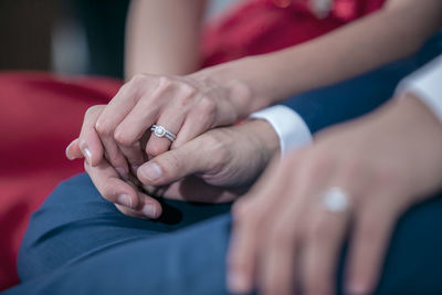 Midsection of couple holding hands