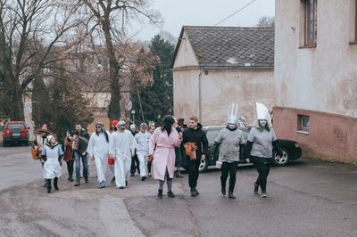 Group of people on street against building