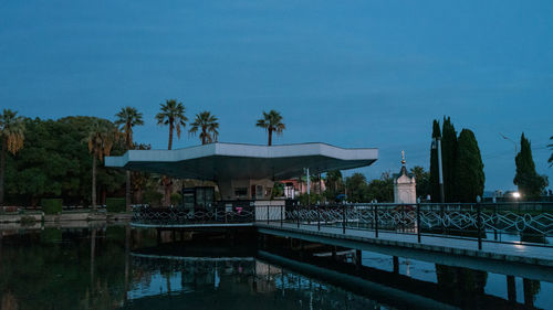 View of swimming pool by lake against sky