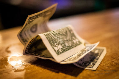 Close-up of currency on wooden table