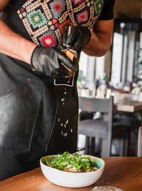 Midsection of man preparing food in kitchen