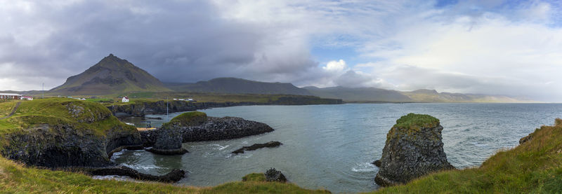 Panoramic view of sea and mountains against sky