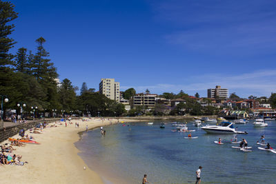 Group of people on beach in city