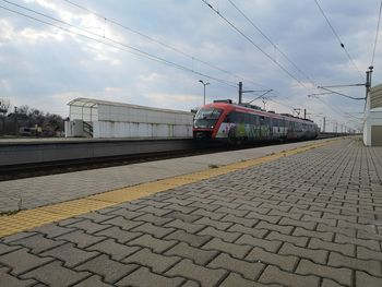 Train at railroad station against sky