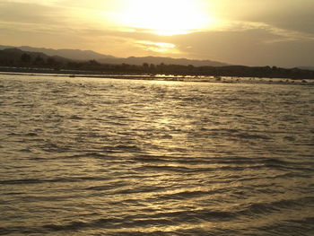 Scenic view of sea and mountains during sunset