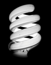 Close-up of spiral light bulb against black background