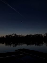 Scenic view of lake against sky at night