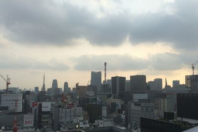 City skyline against cloudy sky