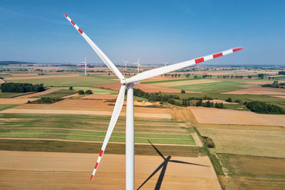 Windmill turbine in the field at summer day. rotating wind generator